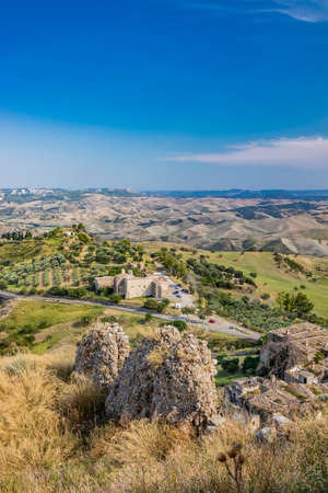 Craco, Matera, Basilicata, Italy. Ghost town destroyed and abandoned following a landslide. Collapsed houses and the remains invaded by vegetation. Broken walls, windows and doors, crumbling balconiesのeditorial素材