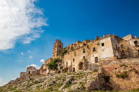 Craco, Matera, Basilicata, Italy. Ghost town destroyed and abandoned following a landslide. Collapsed houses and the remains invaded by vegetation. Broken walls, windows and doors, crumbling balconiesのeditorial素材