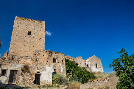 Craco, Matera, Basilicata, Italy. Ghost town destroyed and abandoned following a landslide. Collapsed houses and the remains invaded by vegetation. Broken walls, windows and doors, crumbling balconiesのeditorial素材