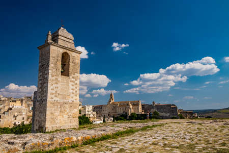 Gravina in Puglia, Italy. The stone bridge, ancient aqueduct and viaduct, over the Gravina stream. The Madonna della Stella Sanctuary, with its bell tower and the ancient cave church.の写真素材