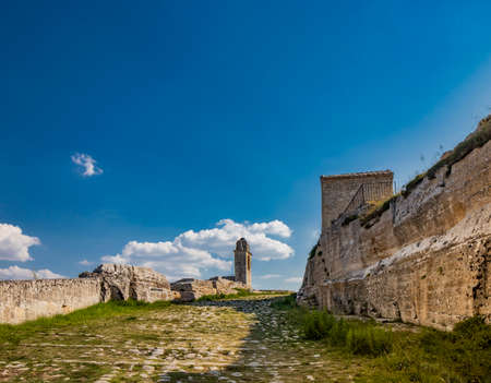 Gravina in Puglia, Italy. The stone bridge, ancient aqueduct and viaduct, over the Gravina stream. The Madonna della Stella Sanctuary, with its bell tower and the ancient cave church.の写真素材