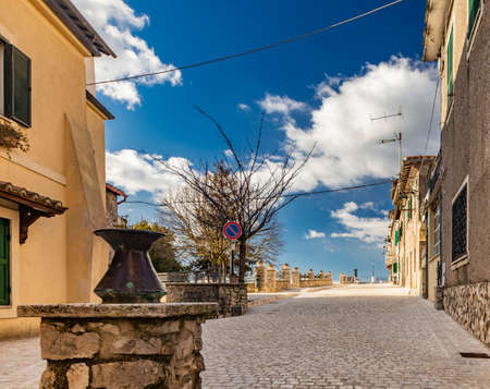 The small medieval village of Castel San Pietro Romano, Lazio, province of Rome, Palestrina. The main street of the village paved with cobblestones, with the houses overlooking the valley.の写真素材