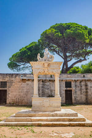 August 10, 2021 - Abbey of Santa Maria a Cerrate, Puglia, Salento, Lecce - Ancient Romanesque church, heritage of the FAI. The facade with the large arch above the portal and the columns on the sides.のeditorial素材