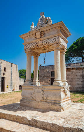 August 10, 2021 - Abbey of Santa Maria a Cerrate, Puglia, Salento, Lecce - Ancient Romanesque church, heritage of the FAI. The facade with the large arch above the portal and the columns on the sides.のeditorial素材