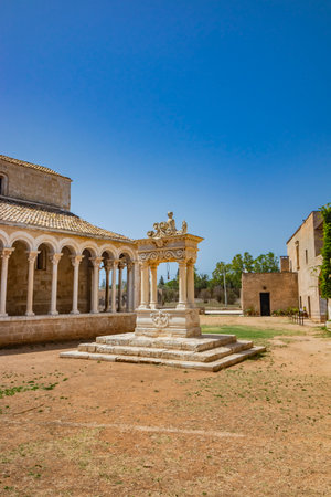 August 10, 2021 - Abbey of Santa Maria a Cerrate, Puglia, Salento, Lecce - Ancient Romanesque church, heritage of the FAI. The facade with the large arch above the portal and the columns on the sides.のeditorial素材