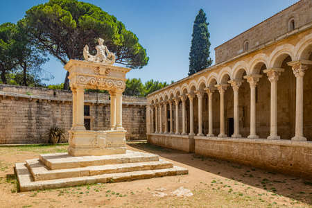 August 10, 2021 - Abbey of Santa Maria a Cerrate, Puglia, Salento, Lecce - Ancient Romanesque church, heritage of the FAI. The facade with the large arch above the portal and the columns on the sides.のeditorial素材