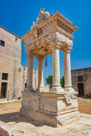 August 10, 2021 - Abbey of Santa Maria a Cerrate, Puglia, Salento, Lecce - The portico at the side of the church, shady and cool, with arches and columns. Shelter from the sun and the summer heat.のeditorial素材