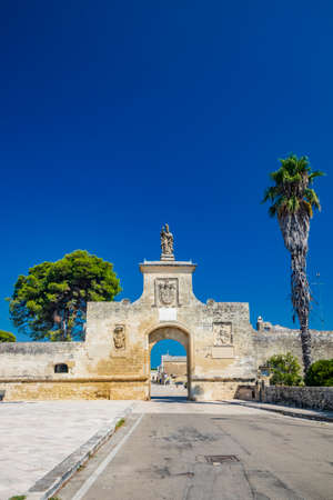 The small fortified village of Acaya, Lecce, Salento, Puglia, Italy. The large stone-paved square. The ancient medieval castle with towers and moat.のeditorial素材