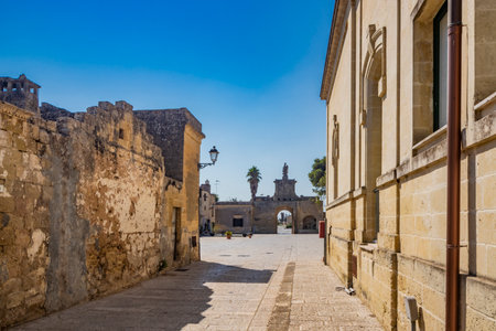 The small fortified village of Acaya, Lecce, Salento, Puglia, Italy. The large stone-paved square. The ancient medieval castle with towers and moat.のeditorial素材