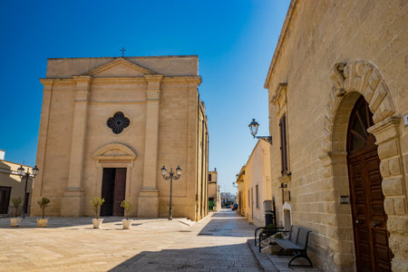 The small fortified village of Acaya, Lecce, Salento, Puglia, Italy. The large stone-paved square. The ancient medieval castle with towers and moat.のeditorial素材