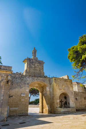 The small village of Acaya, Lecce, Salento, Puglia, Italy. The tower with the clock and the mullioned window. The small square paved in flat stone.のeditorial素材