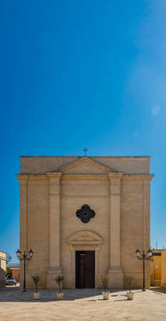 The small village of Acaya, Lecce, Salento, Puglia, Italy. The tower with the clock and the mullioned window. The small square paved in flat stone.のeditorial素材