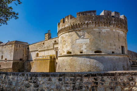 The small village of Acaya, Lecce, Salento, Puglia, Italy. The tower with the clock and the mullioned window. The small square paved in flat stone.のeditorial素材