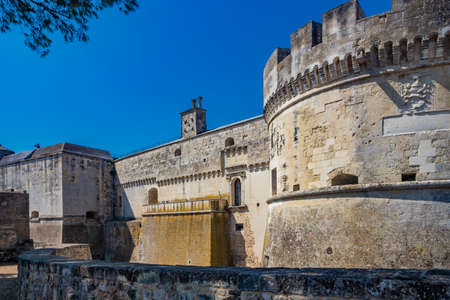 The small village of Acaya, Lecce, Salento, Puglia, Italy. The tower with the clock and the mullioned window. The small square paved in flat stone.のeditorial素材