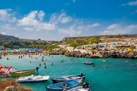 Aug 17, 2021 - Otranto, Puglia, Italy - The small beach of Porto Badisco, famous seaside resort of Salento. Tourists spend their summer holidays. People have fun and swim in the sea.のeditorial素材