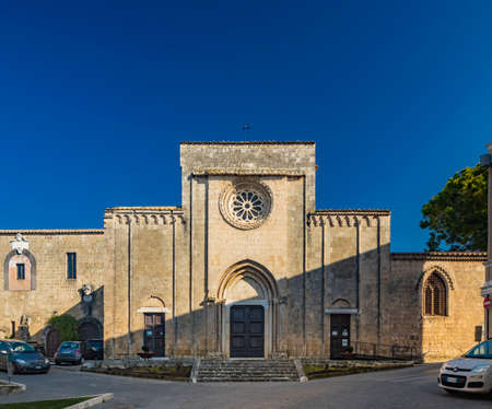 Feb. 6, 2022 - Tarquinia, Viterbo, Lazio, Italy - A glimpse of the main square of the village, seen through a narrow cobbled alley. A street lamp in the blue sky. The municipal theater.のeditorial素材