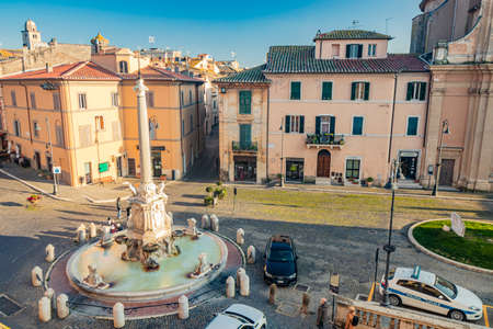 Feb. 6, 2022 - Tarquinia, Viterbo, Lazio, Italy - A glimpse of the main square of the village, seen through a narrow cobbled alley. A street lamp in the blue sky. The municipal theater.のeditorial素材