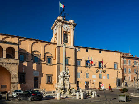 Feb. 6, 2022 - Tarquinia, Viterbo, Lazio, Italy - A glimpse of the main square of the village, seen through a narrow cobbled alley. A street lamp in the blue sky. The municipal theater.のeditorial素材