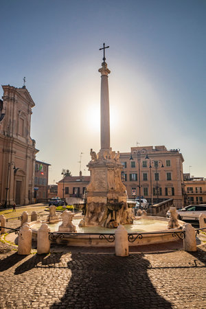 Feb. 6, 2022 - Tarquinia, Viterbo, Lazio, Italy - The main square of the village photographed from above, in the evening. Circular fountain with the obelisk. The light of the waning sun at sunset.のeditorial素材