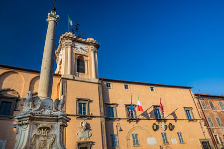 Feb. 6, 2022 - Tarquinia, Viterbo, Lazio, Italy - The main square of the village photographed from above, in the evening. Circular fountain with the obelisk. The light of the waning sun at sunset.のeditorial素材
