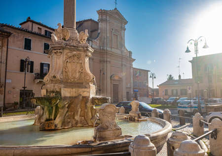 Feb. 6, 2022 - Tarquinia, Viterbo, Lazio, Italy - The main square of the village photographed from above, in the evening. Circular fountain with the obelisk. The light of the waning sun at sunset.のeditorial素材