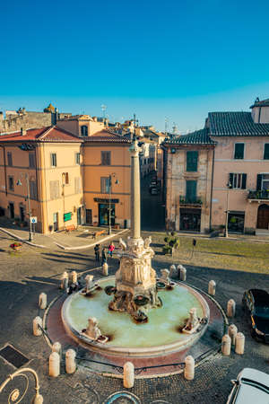 Feb. 6, 2022 - Tarquinia, Viterbo, Lazio, Italy - The main square of the village photographed from above, in the evening. Circular fountain with the obelisk. The light of the waning sun at sunset.のeditorial素材