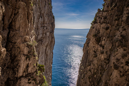 Gaeta, Latina, Lazio, Italy. A splendid view of the city. The old town with its houses overlooking the sea. The Sanctuary of the Holy Trinity on the Montagna Spaccata (split mountain) cliff.の写真素材