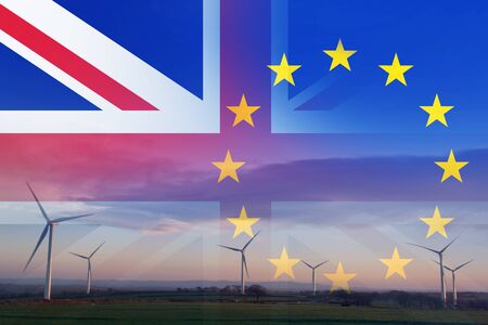 Brexit concept. A wind farm at sunrise with the flags of the Union Jack and the E.U over layered on top. の写真素材
