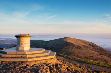 Looking out from toposcope on the top of the Worcestershire Beacon, at misty, sunrise on a winters morning. Malvern Hills, UK.の写真素材
