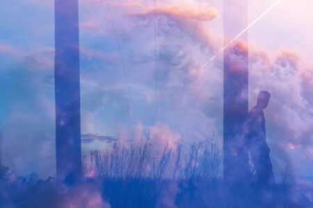 A transparent figure of a man looking up at a plane going across the sky. In a field next to...