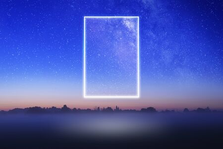 A glowing, portal, gateway floating above a misty field with a galaxy of stars behind. Sceince fiction concept.の写真素材