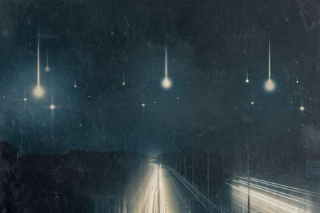Traffic trails at night on a motorway going across the countryside. As UFO's fall from the sky. With...