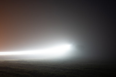 Traffic trails lit up on an atmospheric foggy, winters night