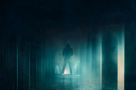A ghostly blurred hooded figure on a city path. With a grunge blurred edit