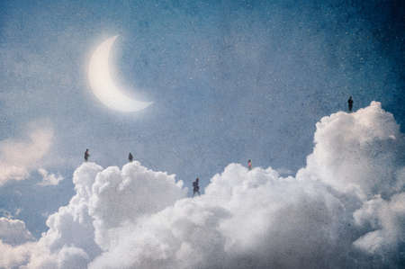 A magical concept. Of isolated people floating on clouds in the sky at night. With a grunge, artistic edit.の写真素材