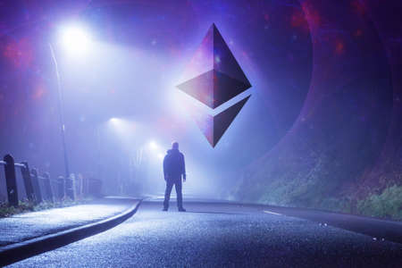 A  cryptocurrency concept. Of the Ethereum symbol. With a science fiction background. With a mysterious man, alone, standing in the middle of a road. Under street lights. On a foggy, nightの写真素材