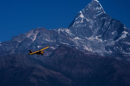 Ultra light flying around Mount Fishtail in Pokhara, Nepalの写真素材