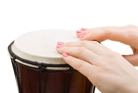 Close-up of girl drummers hands playing percussion isolated on white backgroundの写真素材