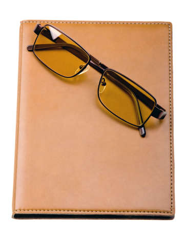 Daily planner with glasses isolated on white backgroundの写真素材