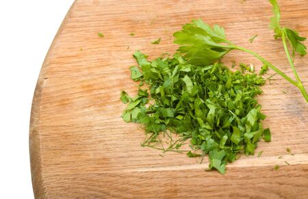 Close-up cutting board with green chopped herbs to backgroundの写真素材