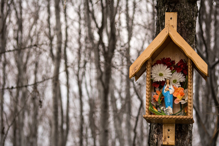 Wooden wayside shrine in the forest Polandの写真素材