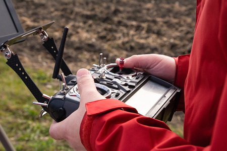 Man use remote control that controls drone