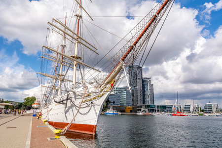 Tourists walk around the marina near sailing ship "Dar Pomorza" (Gdynia, Poland)のeditorial素材
