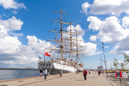 Tourists walk around the marina near sailing ship "Dar Mlodziezy" (Gdynia, Polan ...のeditorial素材