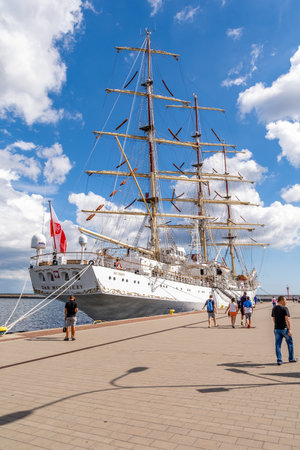 Tourists walk around the marina near sailing ship "Dar Mlodziezy" (Gdynia, Polan ...のeditorial素材