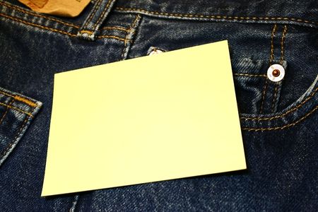 Yellow tag over jeans の写真素材