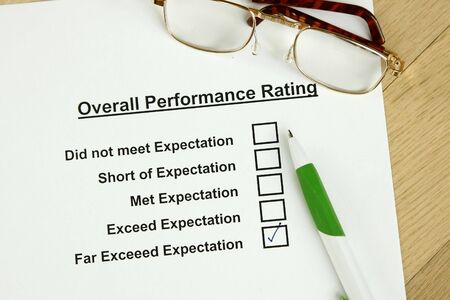 This is an image of an employee performance evaluation and a pair of glasses.の写真素材