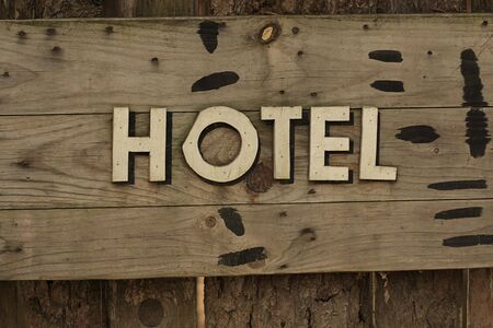 A western style hotel sign on wooden panelの写真素材
