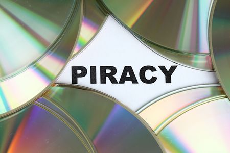 Piracy word written on a pile of dvd disc.の写真素材