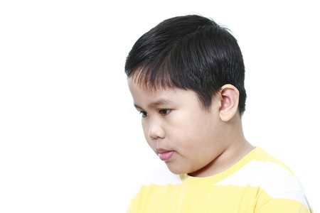 Boy looking - isolated in a white background.の写真素材